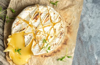 Baked camembert with roasted grapes, walnuts, rosemary and pink peppercorn crackers